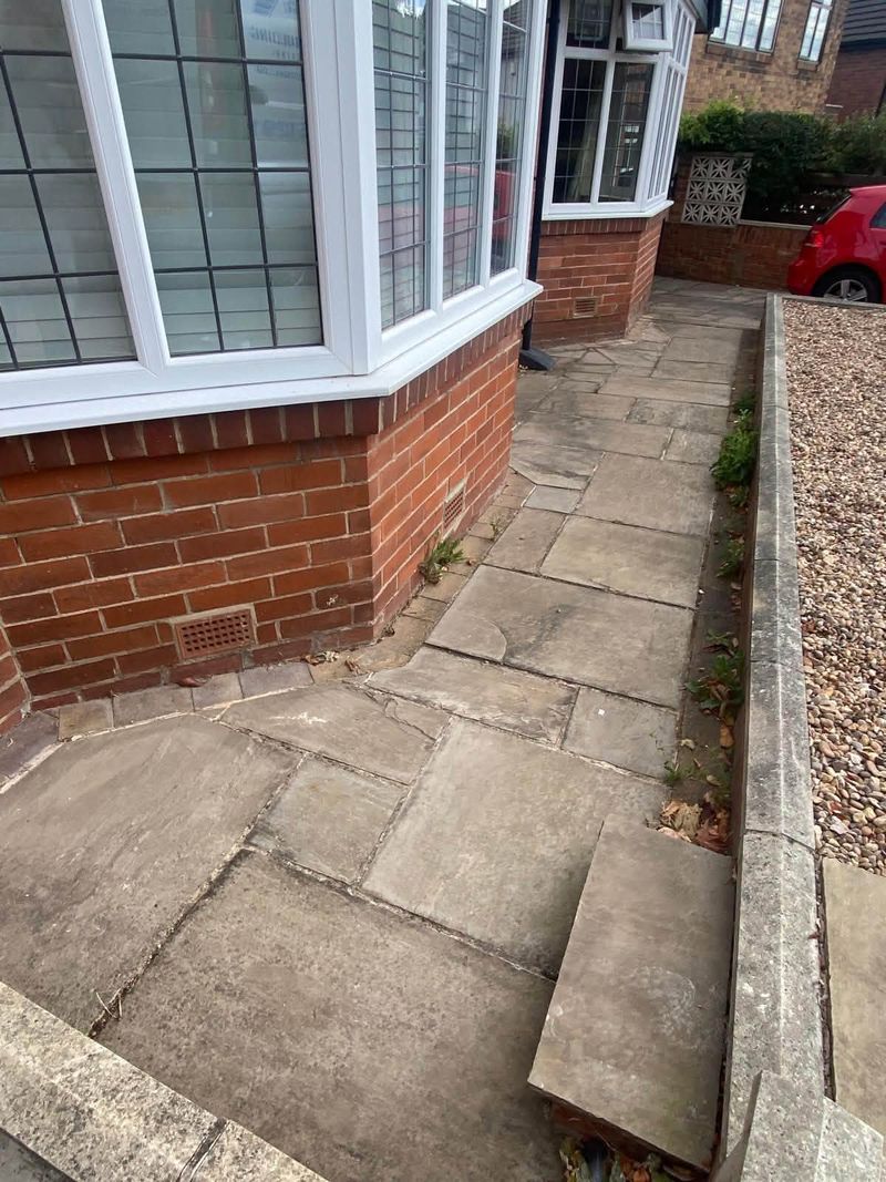 The paved path along the front of the house before the drainage went in