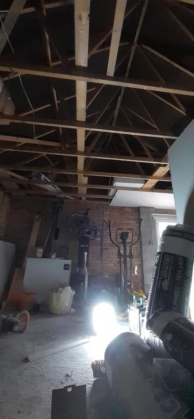 Inside the garage before the work, with the roof timbers exposed