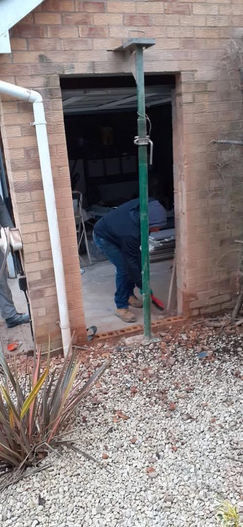 New doorway being formed in the garage wall, supported by an adjustable prop