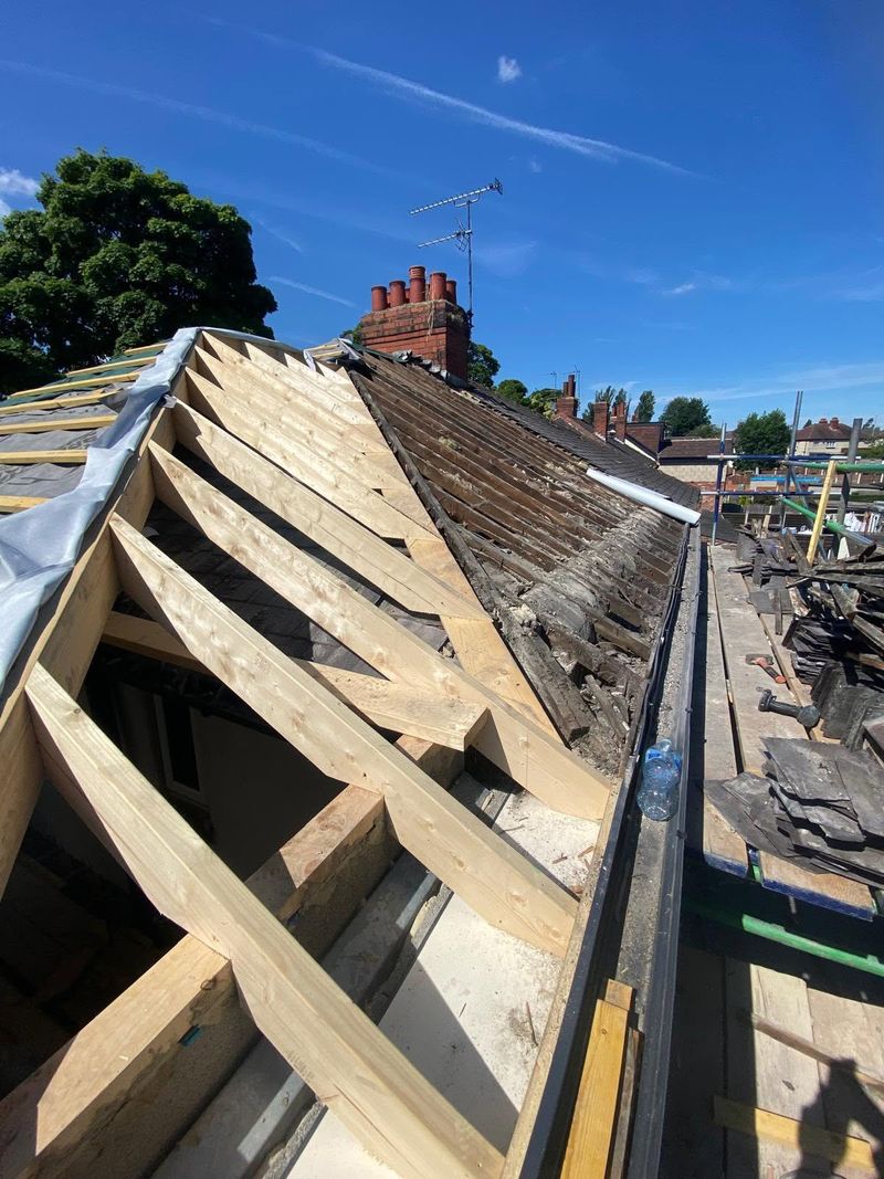 The roof taken back to bare rafters, looking along the hip