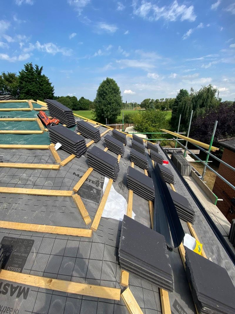New membrane and battens fixed down, with stacks of new tiles ready on the roof