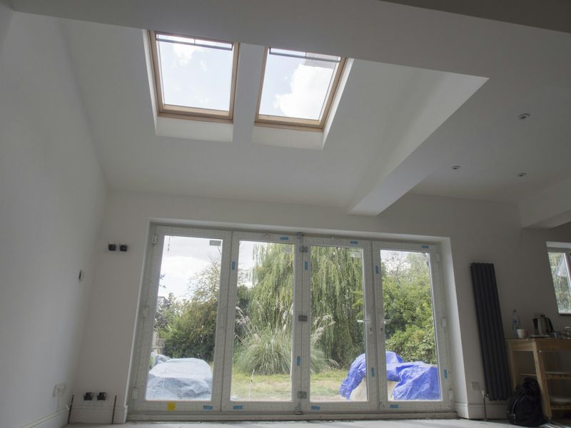 Inside a newly built single-storey rear extension with rooflights and bi-fold doors onto the garden